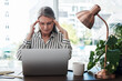 © peopleimages.com - Business woman, headache and stress on computer for deadline, mistake or error of human resource payroll. Mature worker or boss on laptop with migraine, pain or health risk in career, job and office