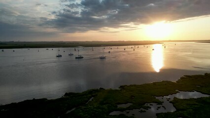 Wall Mural - 4k drone footage of a spectacular sunset over the River Deben at Bawdsey Beach in Suffolk, UK