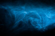 © deliris - Abstract atmospheric smoke cloud. Blue fog haze on dark background. . High quality photo