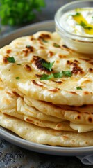 Wall Mural - Savory homemade flatbread stack with fresh herbs and dipping sauce