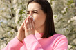 © New Africa - Woman with napkin suffering from seasonal allergy on spring day
