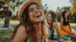 © sommersby - A group of young women enjoying a break, sitting together on top of a grass-covered field under the sun