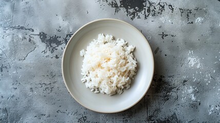 Wall Mural - Rice served on a white plate against a gray concrete backdrop