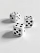 © vefimov - Three white dice are sitting on a white surface. The dice are all the same size and shape, and they are all facing the same direction. Concept of order and uniformity, as the dice are all identical