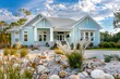 © Counter - A suburban house with a beach cottage style, light blue exterior, white trim, and a front yard filled with seashells and coastal grasses.