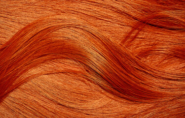 Sticker - Red hair close-up as a background. Women's long orange hair. Beautifully styled wavy shiny curls. Hair coloring bright shades. Hairdressing procedures, extension.