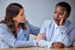 © peopleimages.com - Sad, business woman and hr for therapy, help and emotional support with counselling in office. Stress, female person and manger with hug for care, communication and depression with corporate empathy