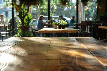 Wall Mural - Wooden table in the foreground, with people sitting at tables and chairs in a restaurant coffee shop or eatery.