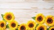 © lattesmile - Bright sunflowers border on light wooden background with copy space