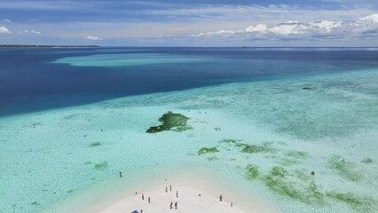Wall Mural - Aerial view of Nakupenda island, sandbank in ocean, white sandy beach, blue sea in low tide on summer day in Zanzibar. Top drone view of sand spit, clear azure water, people, sky with clouds. Tropical