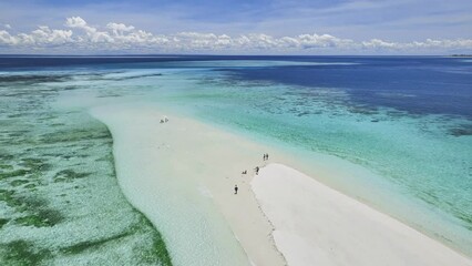 Wall Mural - Aerial view of Nakupenda island, sandbank in ocean, white sandy beach, blue sea in low tide on summer day in Zanzibar. Top drone view of sand spit, clear azure water, people, sky with clouds. Tropical