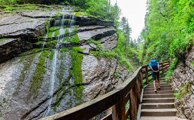 man hiking trough the natural spectacle Wimbachklamm, Gorge in the mountaineering village Ramsau near Berchtesgaden. Wimbachtal lies at the foot of the Watzmann. Wimbachklamm is 200 meters long