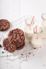 Wall Mural - Tasty and homemade brown cookies served with milk in bottle.