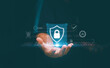 © krungchingpixs - Cyber security and data protection, Businessman holding icon padlock and shield in hand with binary background. Privacy business internet technology. Protecting information from cyber attacks.