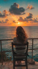 Wall Mural - young girl woman sitting on a chair watching sunset and sea
