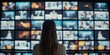 © Marco - Online broadcasting and streaming, woman surrounded by TV screens, video wall showing different TV channel for broadcasting, podcasting, watching and streaming concept