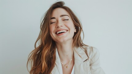 Canvas Print - Stylish and smiling girl portrayed against a white backdrop in a studio