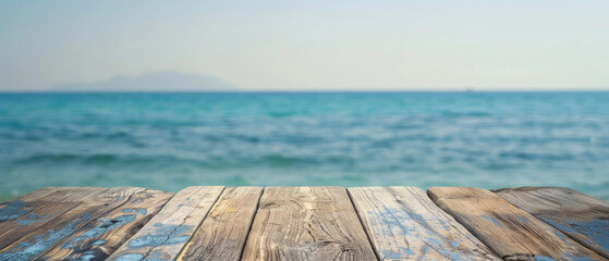 Wall Mural - front view of empty raw wooden plank old table with blurred horizon ocean beach and cloudy blue sky background