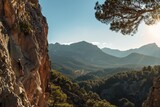 Fototapeta Uliczki - Rock climber on mountain cliff overlooking scenic valley landscape. Outdoor adventure, nature, travel concept