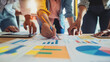 © Teeraphon - Professional business team working on a project together in the office Using economic growth charts and network connections to accompany the data. in analyzing future trends