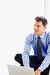© peopleimages.com - Businessman, laptop and smile in office for work in corporate company for online emails with technology. Law clerk, firm and worker or entrepreneur with suit for professional attourney in London
