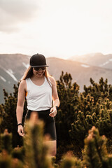 Wall Mural - Young traveler hiking girl with backpacks. Hiking in mountains. Tourist traveler. Hiking in Slovakia mountains landscape. Low Tatras national park, Slovakia.