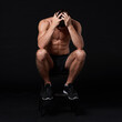 © peopleimages.com - Burnout, fitness and exhausted with sports man in studio isolated on black background for fatigue. Depression, exercise and tired with shirtless athlete or bodybuilder in dark for health and wellness