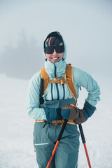 Wall Mural - Mountaineer backcountry ski walking ski alpinist in the mountains. Ski touring in alpine landscape with snowy trees. Adventure winter sport. Low Tatras, slovakia