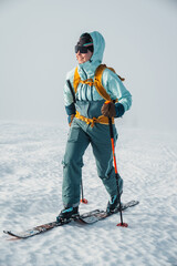 Wall Mural - Mountaineer backcountry ski walking ski alpinist in the mountains. Ski touring in alpine landscape with snowy trees. Adventure winter sport. Low Tatras, slovakia