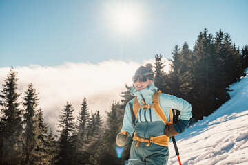 Wall Mural - Mountaineer backcountry ski walking ski alpinist in the mountains. Ski touring in alpine landscape with snowy trees. Adventure winter sport. Low Tatras, slovakia