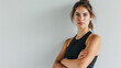 © Александр Марченко - Serious woman in a black sports top with arms crossed.