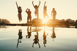© Jacob Lund - Group of friends enjoying good times and travel by jumping into water at sunset