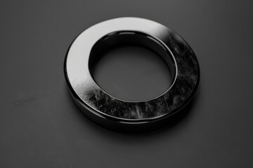 Wall Mural - A black and white photo of a ring on a table. Suitable for jewelry stores promotions
