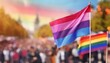 © Arthur - bisexual flag on the background of the pride parade, lgbt pride month, fight against homophobia, tolerance, rally of many people