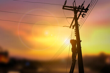 A technician work on high electricity pole silhouette style