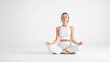 © Rysak - Woman in white meditating in lotus pose