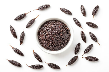 Wall Mural - Black Rice in a Bowl and Scattered on a White Background