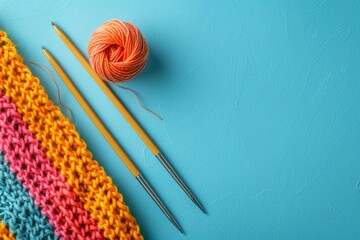 Wall Mural - Balls of thread with 2 needles is on blue background. Copy space for text