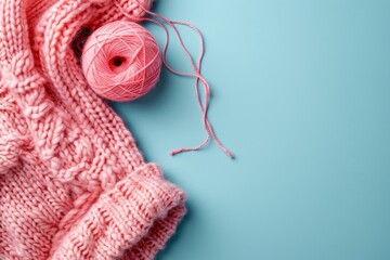 Wall Mural - ball of thread and a knitted fabric on a blue background