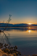 Wall Mural - Sunset over Lake Vasman in Ludvika County, Sweden and the colorful sky with clouds