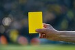 © GHArtwork - Soccer / football referee showing a yellow card in a match