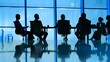 © Felippe Lopes - Silhouetted board members engage in a serious discussion around a conference table in a modern office setting against a blue-tinted window.
