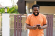 © Art_Photo - African man use smartphone of connectivity technology, digital engagement and active, digital communication, modern lifestyle, technology use in everyday life, remote work, social media and online