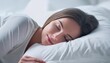© Marko - Peaceful beautiful young lady sleeping in cozy white bed on soft pillow