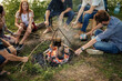© alfa27 - teenagers are learning to cook sausages on fire. yop view photo