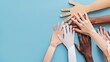 © ant - Colorful cut out paper hands of different skin colors reaching up on a blue background.