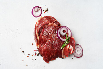 Wall Mural - Piece of raw meat beef with onion and seasoning, pepper and rosemary