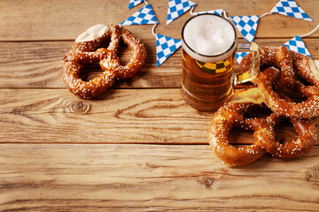 Octoberfest concept with traditional pretzel, beer and flag pattern