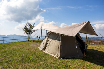 camp site tent over the mountain under sunny day