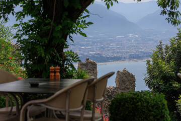 Wall Mural - Beautiful views from above, tables in a cafe in the mountains and a panoramic view of the city, public places in Turkey, on a sunny summer day